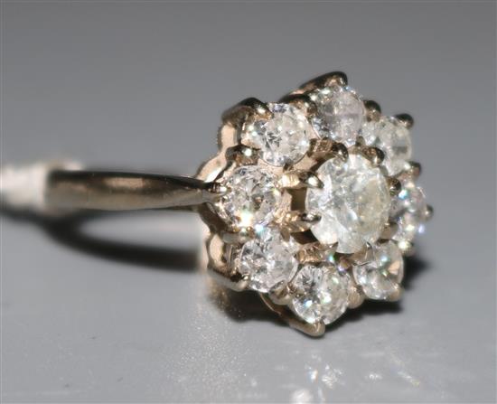 An 18ct white gold and diamond cluster ring, size N.